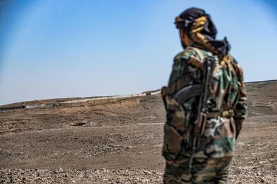 A member of the border guard force loyal to the Syrian Democratic Forces (SDF) patrols the area. AFP