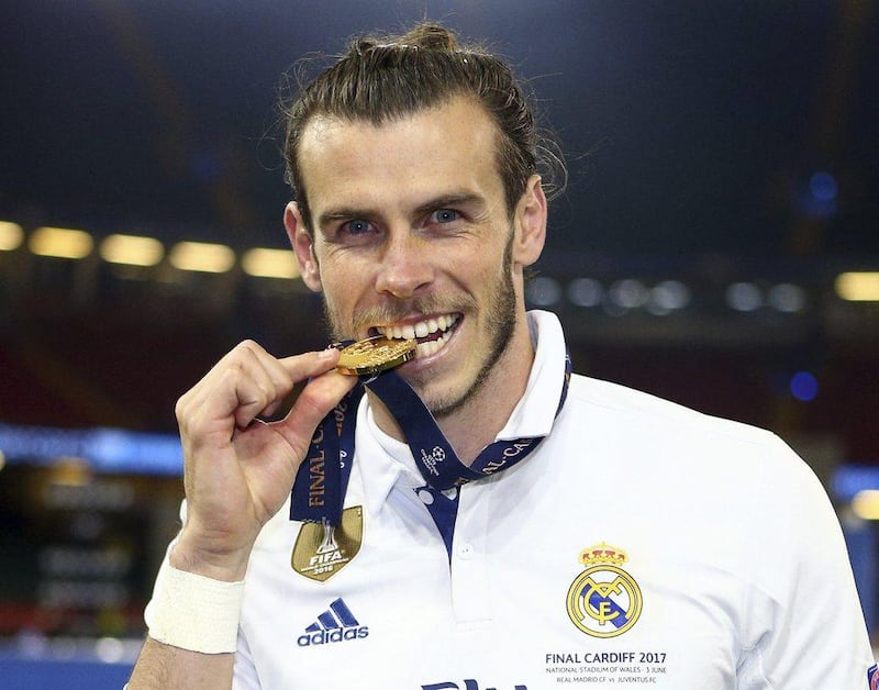 Real Madrid's Gareth Bale bites his winners medal at the end of the Uefa Champions League final against Juventus at the Millennium Stadium in Cardiff, Wales, Saturday, June 3, 2017. Real won the match 4-1. Frank Augstein / AP Photo