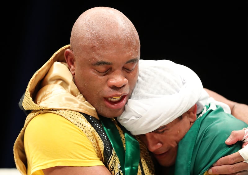 Anderson Silva and Bruno Machado (R) embrace after their bout.