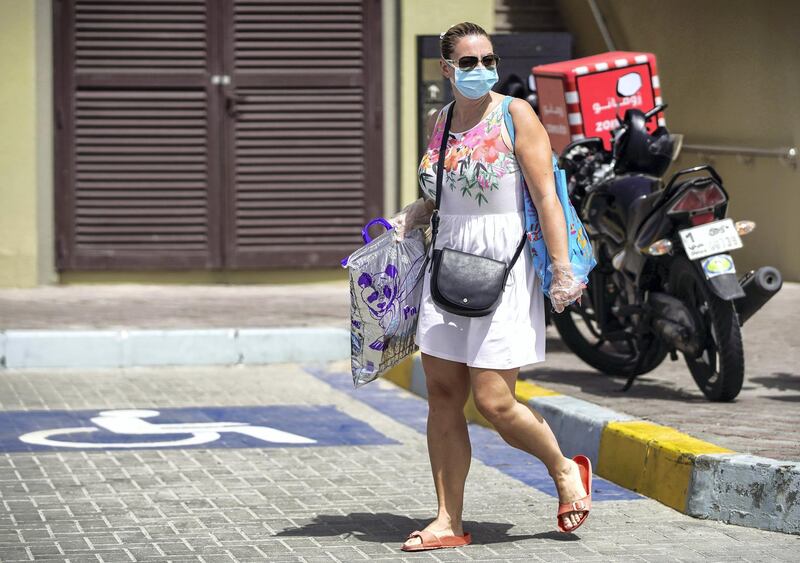 Abu Dhabi, United Arab Emirates, April 5, 2020.  A grocery shopper with a face mask on at Souk Planet, Khalifa City.  Face masks should be worn at all times when outside the home, the UAE government said on Saturday.      
Victor Besa / The National