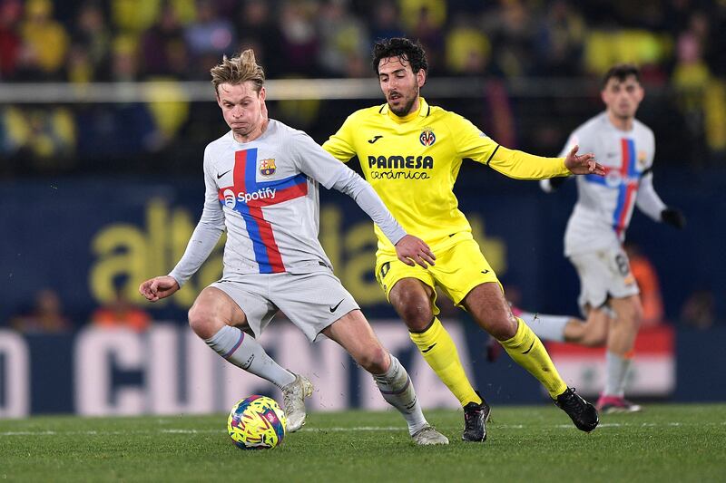 Barcelona midfielder Frenkie de Jong on the ball under pressure from Villarreal's Dani Parejo. Reuters