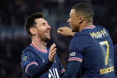 PSG's Kylian Mbappe, centre, celebrates with PSG's Lionel Messi after scoring his side's second goal during the French League One soccer match between Paris Saint-Germain and Monaco at the Parc des Princes stadium in Paris, France, Sunday, Dec.  12, 2021.  (AP Photo / Christophe Ena)