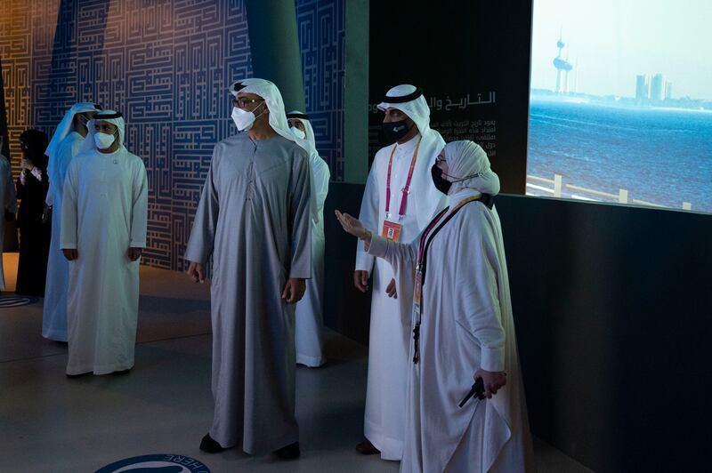 Sheikh Mohamed bin Zayed is briefed on the exhibits at the Kuwait pavilion.