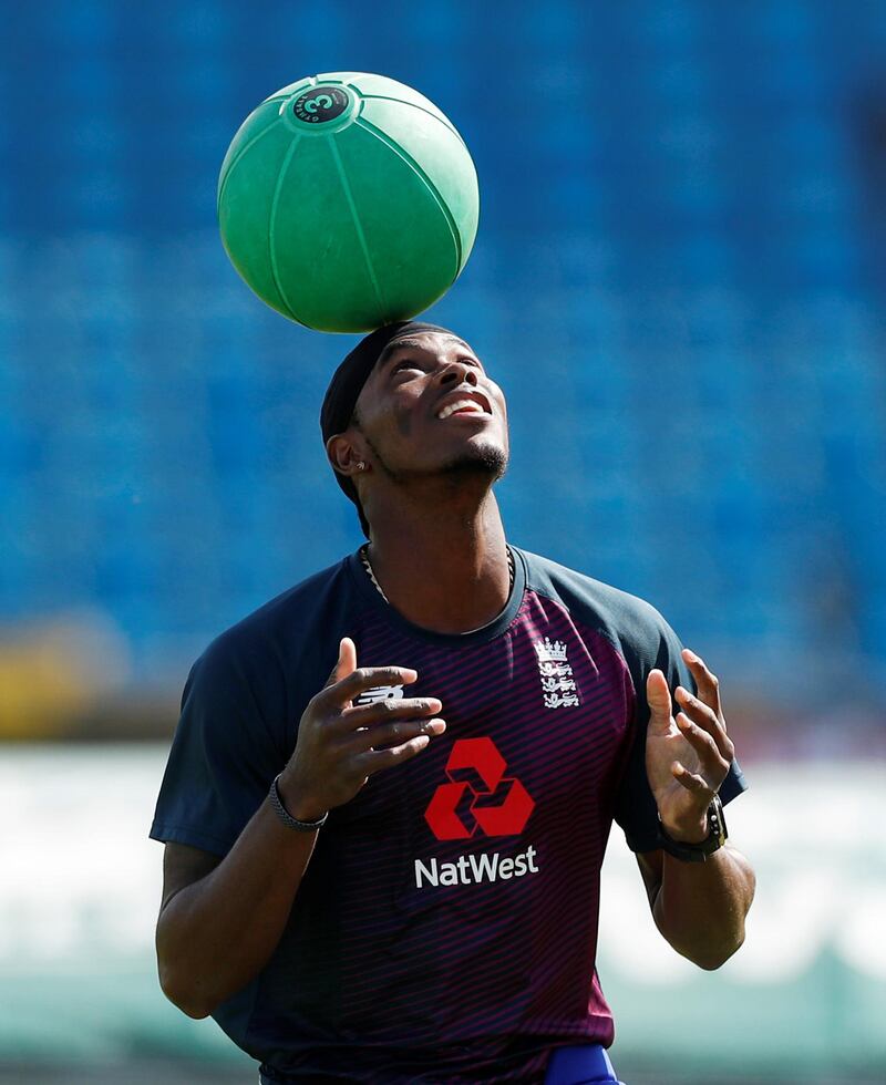 England's Jofra Archer balances a ball on his head. Reuters