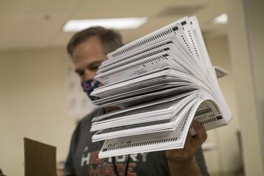 A worker holds ballots inside a counting room at the Contra Costa County Clerk Office in Martinez, California on October 27, 2020. Bloomberg