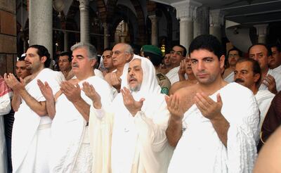 Rafik Hariri, second left, and his two sons Saad, left, and Bahaa performing the Umrah pilgrimage in Mecca in 2003. AFP