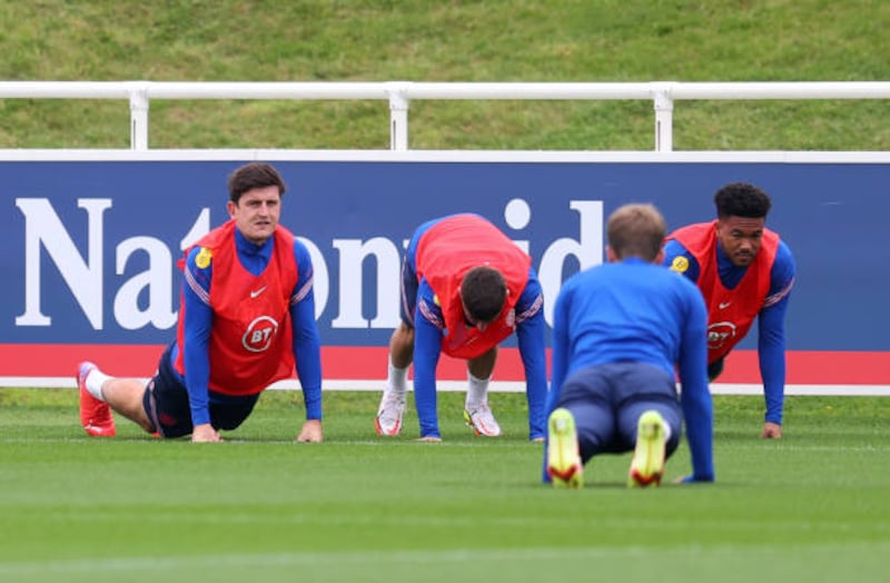 Harry Maguire, left, stretching at training. Getty