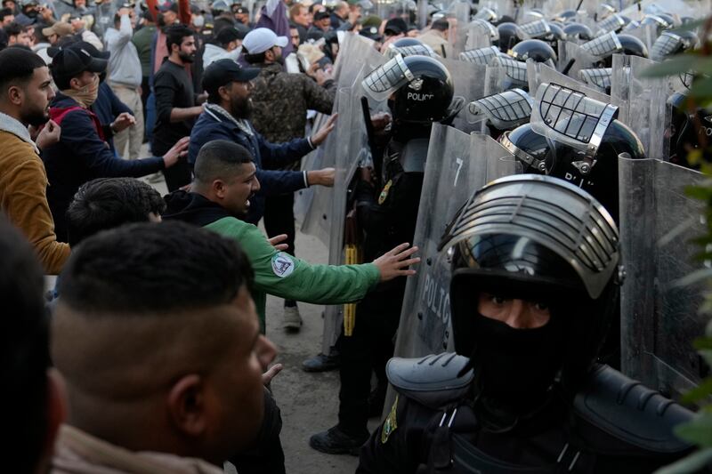 Security forces try to disperse Baghdad protesters. AP