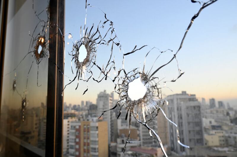 Bullet holes on a window of an apartment building. EPA