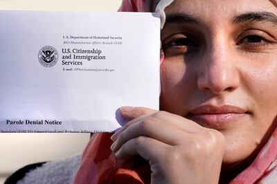 An Afghan woman holds a parole denial notice she received from the Department of Homeland Security. AP