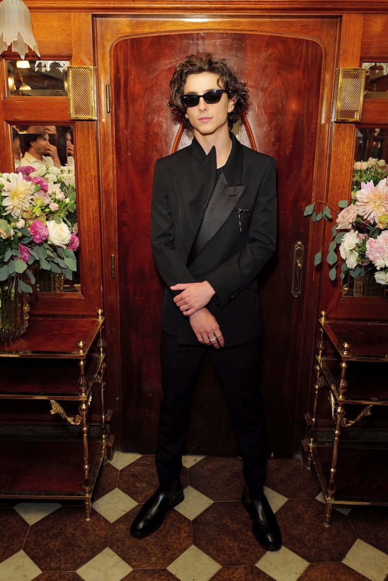 Timothee Chalamet, in a black Alexander McQueen suit and sunglasses, attends the British Vogue Celebrates Vogue Darlings party at Venice Film Festival on September 2, 2022. Photo: Darren Gerrish/WireImage for Vogue