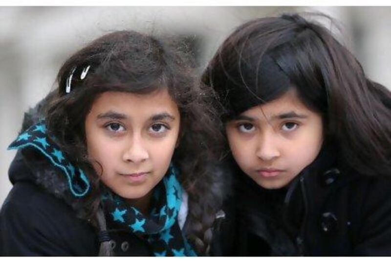 Sara Qurashi, 13, left, and her cousin Saamiya Qurashi, 9, outside the UAE Embassy in London where her family are staging a protest on behalf of Sara's father, who is serving a seven-year prison sentence.