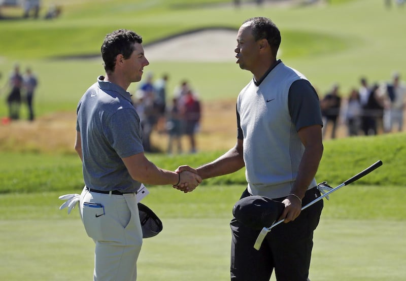 Tiger Woods, right, and Rory McIlroy shake hands at the end of their first round of the Genesis Open golf tournament at Riviera Country Club in the Pacific Palisades neighborhood of Los Angeles Thursday, Feb. 15, 2018. (AP Photo/Reed Saxon)