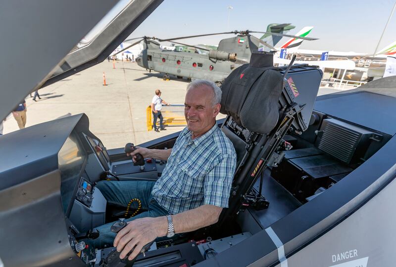 Cary Jacobson sits at the controls of a full scale mock-up of the F-35.