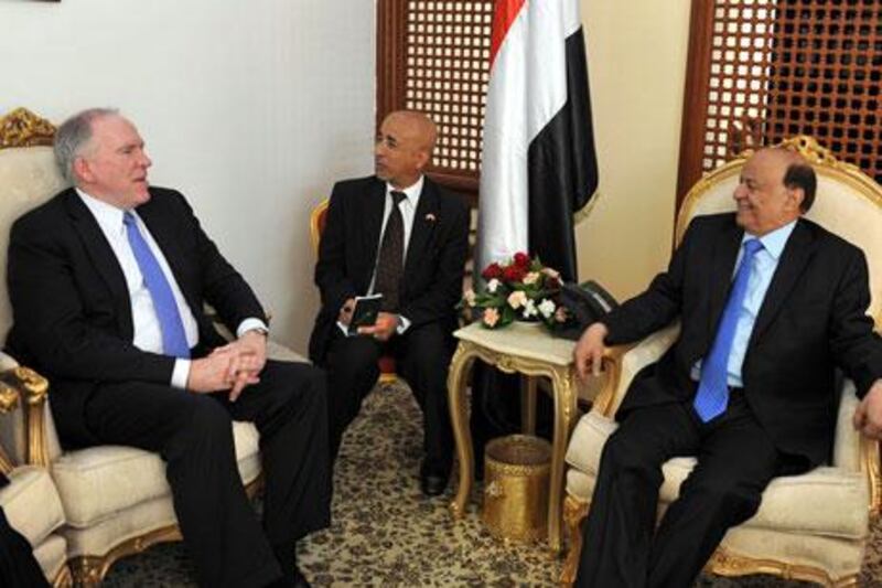 John Brennan, left, meets Yemen's interim president, Abdrabu Mansur Hadi, right, in May. Sources say Mr Brennan had knowledge of the CIA's use of controversial interrogation techniques during an earlier stint with the agency. EPA