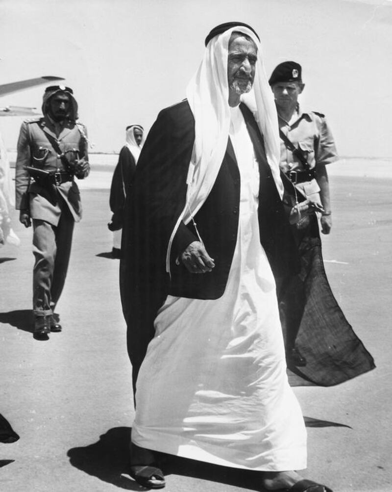 Sheikh Rashid bin Saeed Al Maktoum with the chief of police, Jack Briggs, behind him at Dubai Airport, in 1960. Keystone Features / Hulton Archive / Getty Images