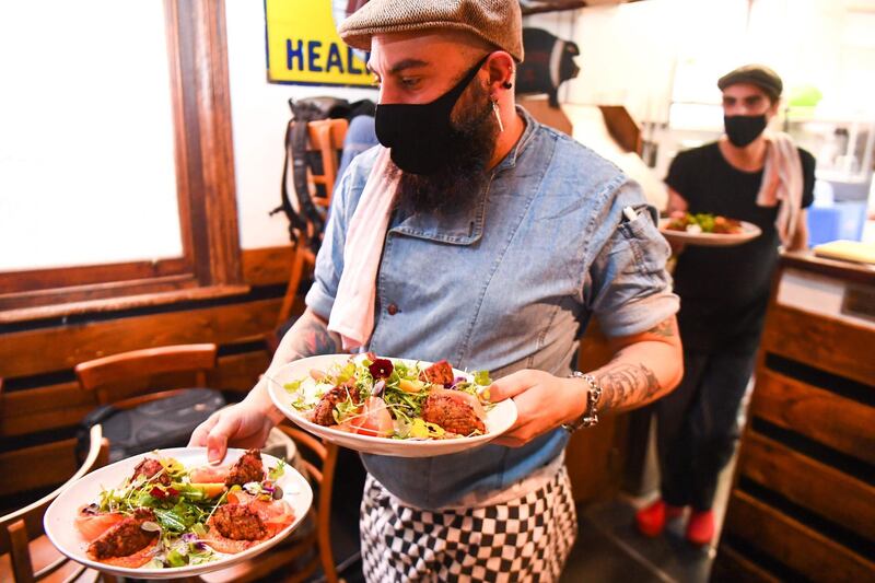 Chefs prepare meals for testing during a staff orientation day as Tiamo Bistro readies for opening in Melbourne, as the state government lifts some restrictions on retail and restaurants after the city battled a second wave of the Covid-19 coronavirus. AFP