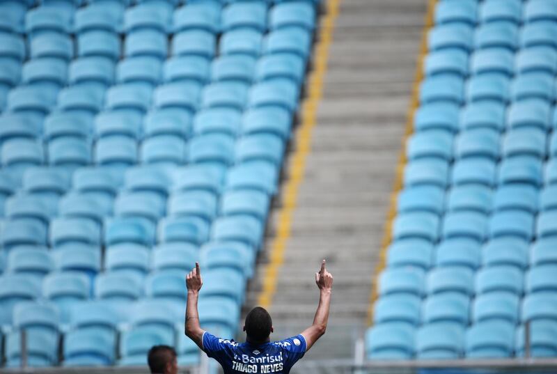 Gremio's Thiago Neves celebrates after scoring a goal in front of empty stands. Reuters