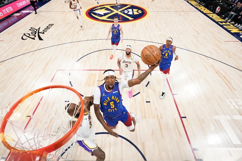 Denver Nuggets guard Kentavious Caldwell-Pope rises to shoot against Los Angeles Lakers forward LeBron James, left, during the first half in Game 1 of an NBA basketball first-round playoff series. AP Photo