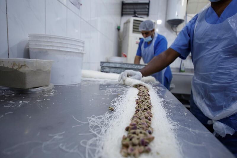 Traditional sweets are prepared for sale days before Eid Al Fitr at a shop in Baghdad. Reuters