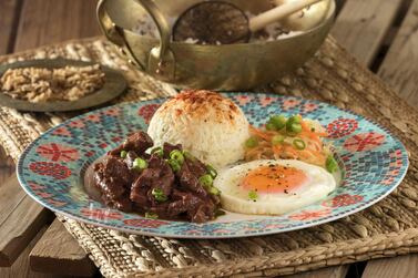 A traditional Filipino breakfast dish with beef, egg and fried rice.