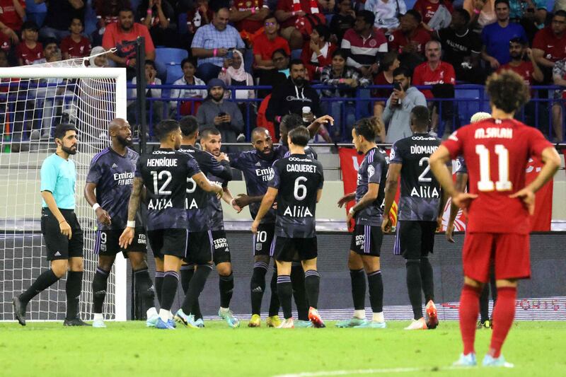 Lyon's players celebrate scoring a goal. AFP