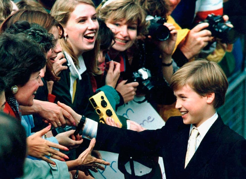 1991: Prince William shakes hands with royal fans during a visit to St. James Cathedral in Toronto, Canada. AP Photo