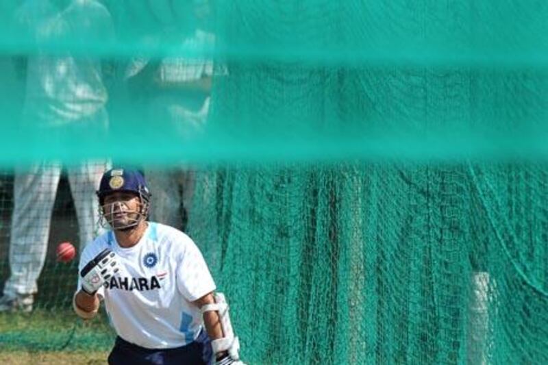 Indian cricketer Sachin Tendulkar throws the ball back to the bowler after playing a shot in the nets during a training session of the Indian cricket team in Mohali on September 30, 2010. India will play two test and three One Day International (ODI) against Australia starting from October 1. AFP PHOTO/Dibyangshu SARKAR