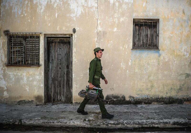 A member of the Cuban army gets ready to fumigate against the Aedes aegypti mosquito to prevent the spread of zika, chikungunya and dengue in a street in Havana. Yamil Lage / AFP Photo