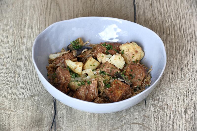 Dubai, United Arab Emirates - May 14, 2019: Iftar Signature Dish. Chicken Makloubeh from Kcal. Tuesday the 14th of May 2019. Healthcare City, Dubai. Chris Whiteoak / The National

Chefs description: Cubes of roast chicken breast marinated in Middle Eastern spices topped with roast cauliflower, aubergine, potato and a tomato flavoured rice, served with yoghurt cucumber sauce. Our Chicken Makloubeh is a twist on an Arabic traditional dish but cooked in a healthy way with zero preservatives or oil. Our chicken is marinated for 24 hours before being steamed to retain the moisture and flavour, unlike the traditions of frying the chicken.