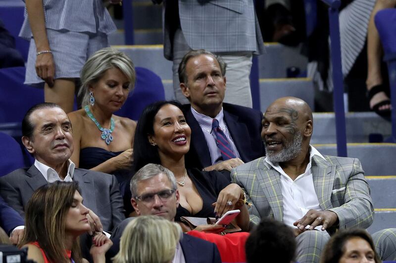 From left: Chazz Palminteri, Lakiha Spicer and Mike Tyson attends the first-round match between Maria Sharapova of Russia and Serena Williams of the United States. Getty Images
