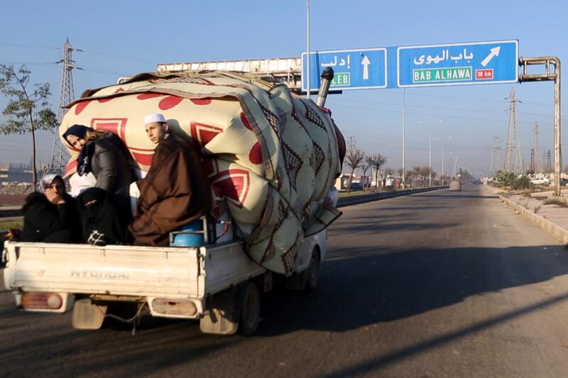 In this frame grab from video a family with their goods loaded on a lorry drives towards the Turkish border in Syria's rebel-controlled Idlib province. AP Photo