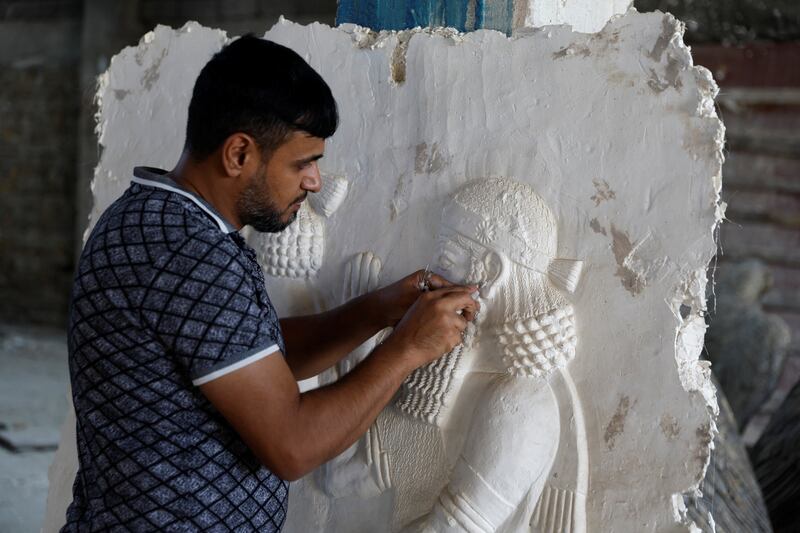 The sculptor Khaled al-Abadi works inside his workshop on his sculptures which depict scenes from the history of the city of Mosul, in Mosul, Iraq, September 15, 2022.  REUTERS / Khalid al-Mousily
