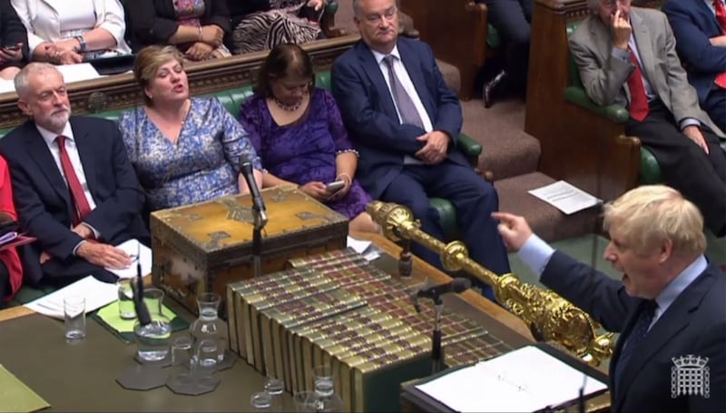 Johnson gestures toward the opposition benches as he stands a the dispatch box. PRU / AFP