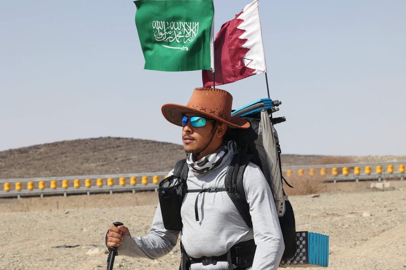 Saudi trekker Abdullah Alsulmi crosses a desert area near al-Khasrah area, some 350Km west of Riyadh, on Septembre 27, 2022, during his solo trek to the Qatari capital ahead of the FIFA World Cup.  - The idea hit Alsulmi earlier this year, while he was watching a television show in which a senior Qatari official promised an "exceptional" experience at the upcoming World Cup.  His excitement building, the 33-year-old Saudi recalls thinking: "I will go to Doha no matter what, even if I have to walk!" (Photo by Fayez Nureldine  /  AFP)