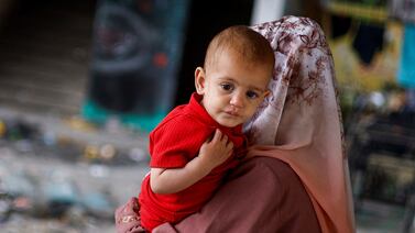 A woman and child at a shelter in Rafah, southern Gaza, where the European Hospital is shutting down services as fuel supplies dwindle. Reuters
