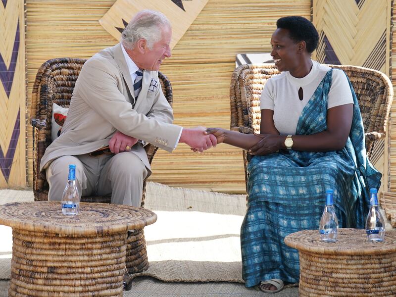 Prince Charles talks to a survivor on his visit to the Mybo reconciliation village in Nyamata. PA