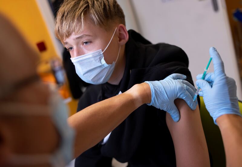 A doctor vaccinates a 13-year-old boy in Berlin. Reuters