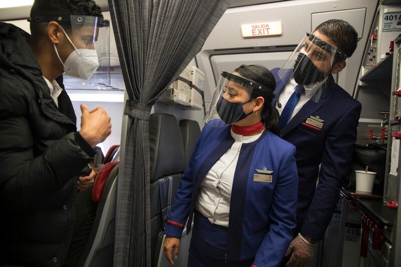 Flight attendants from the LAN company listen to a passenger minutes before a flight take-off from Lima to Pucallpa, Peru. AP Photo