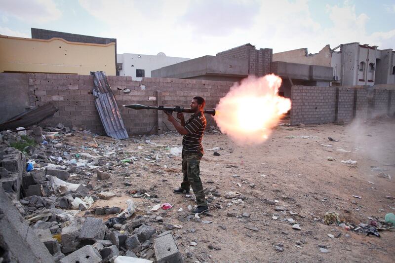 A revolutionary fighter fires a rocket-propelled grenade at Gadhafi loyalists in downtown Sirte, Libya, Tuesday, Oct. 18, 2011. About 1,000 Libyan revolutionary troops have launched a major assault on Moammar Gadhafi's hometown, surging from the east to try to capture the last area under loyalist control. (AP Photo/Manu Brabo) *** Local Caption ***  APTOPIX Mideast Libya.JPEG-01bec.jpg