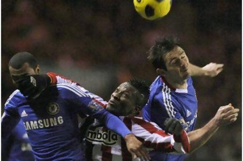 Chelsea's Ashley Cole, left, and Frank Lampard battle Sunderland's Asamoah Gyan on Tuesday.