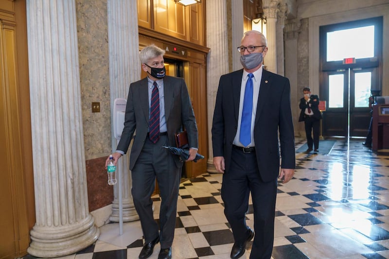 Rep. Bill Cassidy, left, and Rep. Kevin Cramer, arrive for votes during a rare weekend session to advance the confirmation of Judge Amy Coney Barrett to the Supreme Court, at the Capitol in Washington. AP Photo