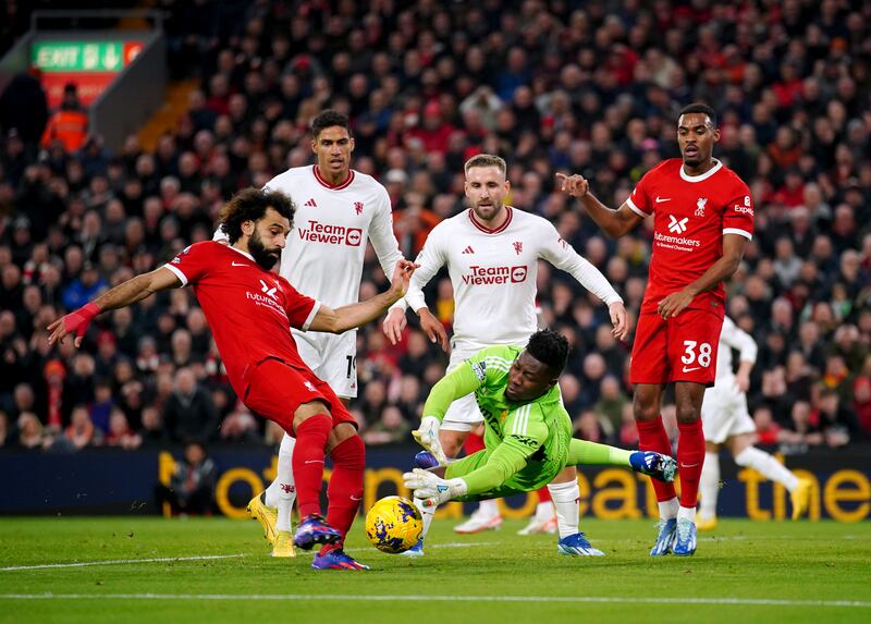 Manchester United goalkeeper Andre Onana saves a shot from Liverpool's Mohamed Salah. PA 