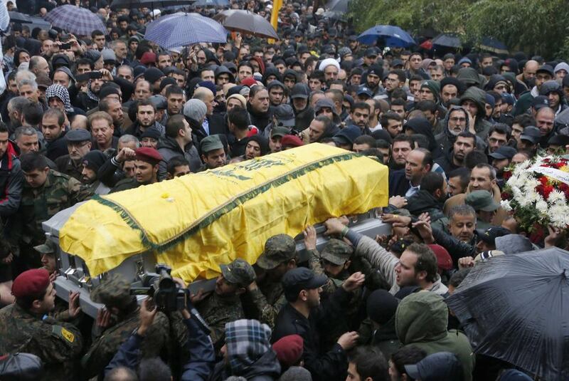 Hizbollah members and relatives carry the coffin of commander Hassan Al Laqis during his funeral in Baalbeck, in Lebanon's Bekaa valley, on Wednesday. Mohamed Azakir / Reuters