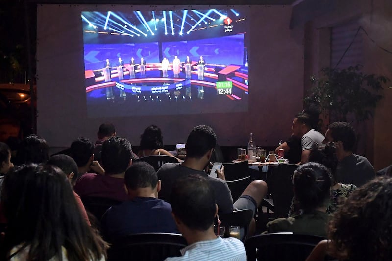 Tunisian poeple watch the Presidential TV debate in a cafe  in Tunis. Days before the first round of Tunisia's presidential election, the fledgling democracy is holding three nights of televised debates between the candidates, a rare event in the Arab world. AFP