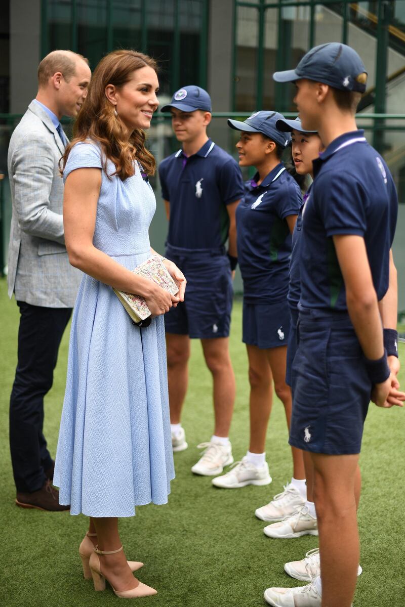 Catherine, Duchess of Cambridge and Prince William, Duke of Cambridge  meet ballboys and ballgirls (left to right) Tom Hubner, 15, Rhianne Black, 14, Kayleigh Man, 13 and Cassius Hayman, 15, ahead of the Men's Singles Final on day thirteen of the Wimbledon Championships at the All England Lawn Tennis and Croquet Club, Wimbledon on July 14, 2019, in London, England. Photo: Getty