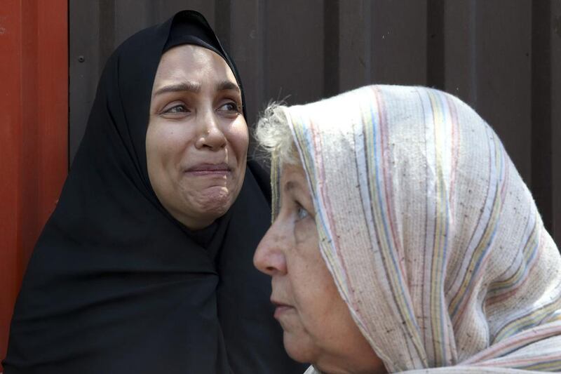 Mary Rezaian, mother of detained Washington Post correspondent Jason Rezaian, speaks with the media as Jason's wife Yeganeh, a correspondent for The National,  weeps, after a hearing at the a court in Tehran on Monday, July 13. (AP Photo/Vahid Salemi)