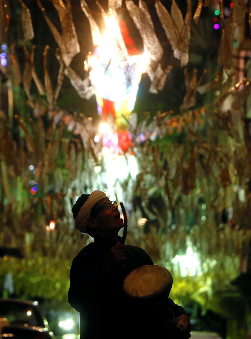 Al-Masharty Moustafa, 60, beats a drum as he wakes residents to eat their pre-dawn Suhoor meals before beginning their fasting for the day during the Muslim Holy month of Ramadan, in Cairo, as Egypt ramps up efforts to slow the spread of the coronavirus disease (COVID-19). REUTERS