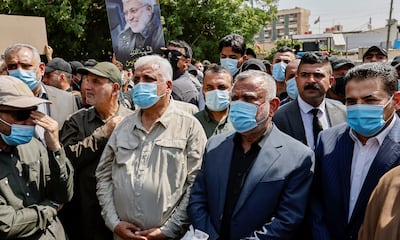 Iraq's national security adviser Qasim Al Araji, right, pictured in 2022 alongside Iraqi militia commander Hadi Al Amiri, second from right, and Faleh Al Fayyad, head of the Popular Mobilisation Forces, third from right. Reuters