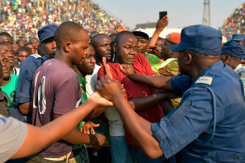 Members of the public scuffle with police and military personnel during a surge to view the body of Zimbabwe's late former president, Robert Mugabe lying in state at the historic Rufaro stadium. Mugabe's family and the government appeared to be deadlocked, over his final resting place after relatives snubbed a plan for him to be buried at a national monument. Mugabe died in Singapore last week aged 95, leaving Zimbabweans divided over the legacy of a leader once lauded as a colonial-era liberation hero, but whose autocratic 37-year rule ended in a coup in 2017. AFP
